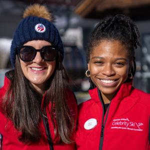 Two women wearing "Celebrity Ski" vests