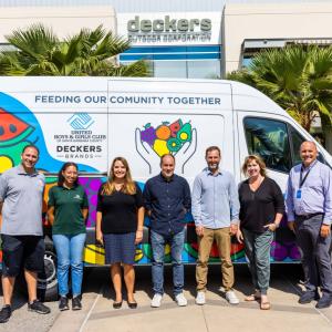 group of employees standing in front of van 