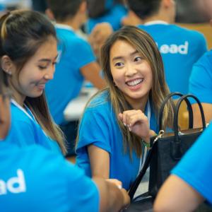 people in blue shirts smiling