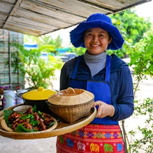 Woman holding tray of food 