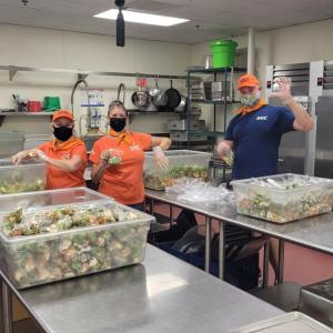 SAIC employees in San Diego, who are also members of the company's Equality Alliance Employee Resource Group, prep meals at Mama's Kitchen on  Sept. 15, 2022. 