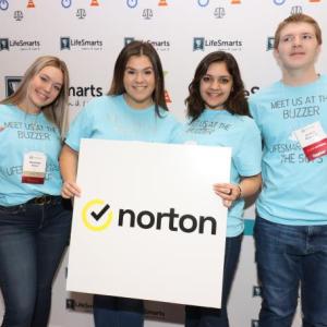4 students holding a Norton sign
