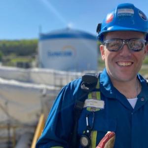 Michael Vickers in suncor uniform and safety gear.