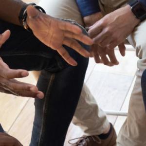 group of hands at a meeting