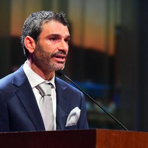 A person speaking into a microphone 