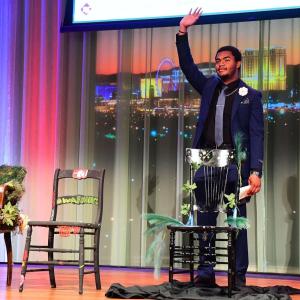 A person stood on stage waving 