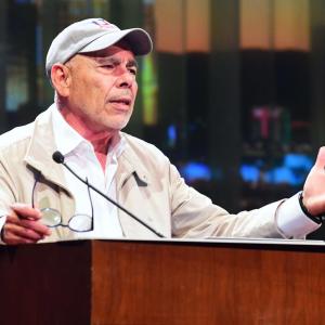 A person speaking into a microphone 