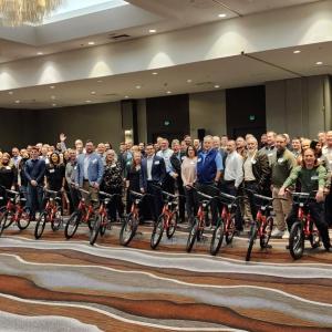 Arrow electronics employees pose with newly built bikes.