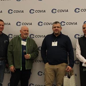 Four people standing together