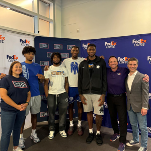 FedEx volunteers posing with USO members
