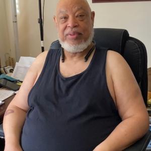 Ronald seated in his home.