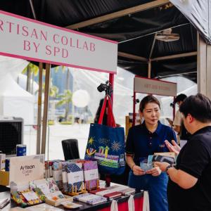 Two people talking at a booth