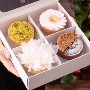 Someone holding a box of pastries