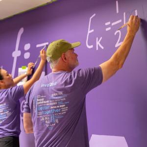 Pasadena employees painting science-themed murals. 