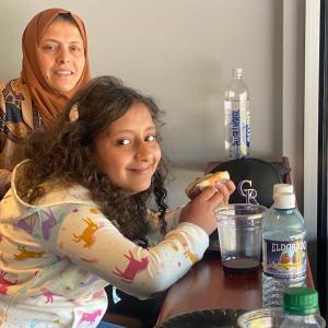 A girl and her mom enjoying a hotdog at the Rockies Opening Day