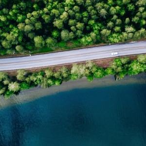 overhead image of cars driving along a windy road 