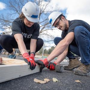 2 arrow employees put a frame together