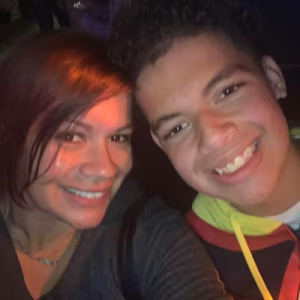 An adult and child smiling together