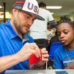 Volunteer and child working on project