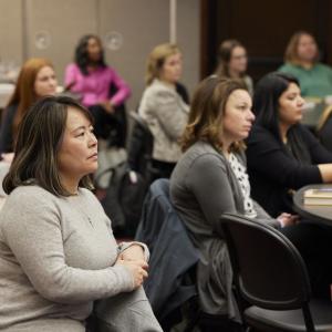An audience sat at tables 