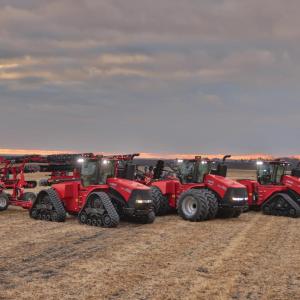 three tractors in an open field