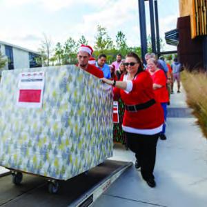 People rolling a box outside