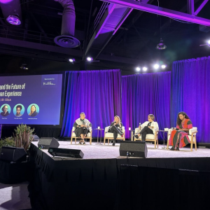 People sat on stage in front of an audience at the 2024 WELL Conference