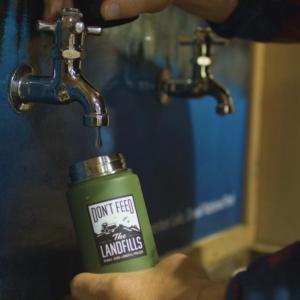 A person refilling a water bottle 