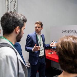 people gathered around a display and listening