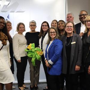 People standing together with a ribbon