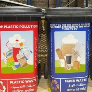Four containers with labels indicating different types of waste
