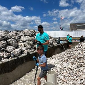 A child and adult helping to clean up the coast
