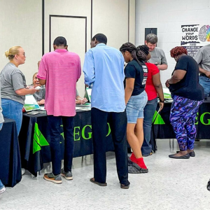 People walking around tables at an event