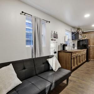 Living room with couch, kitchen and bathroom visible