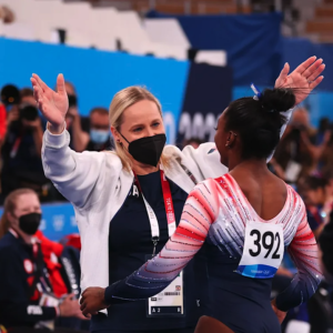 Someone about to hug a gymnast