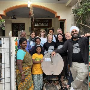 a group of people standing with a dishwasher