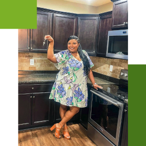 Person in a kitchen, holding up keys