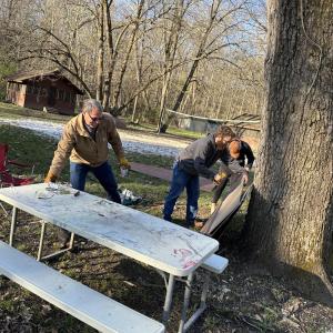 People working near a picnic table