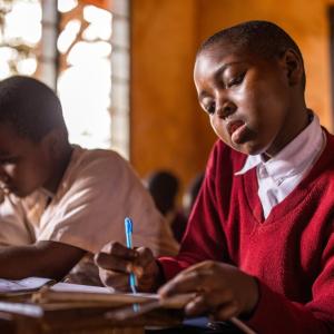 Suzana, 9, in her classroom in Tanzania.
