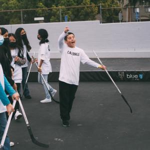 Students have fun participating in a ball hockey clinic following the shoe distribution. 