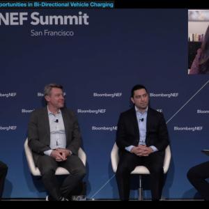 4 speakers sitting on stage with one on video call in the top right corner