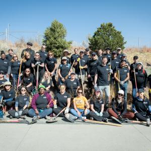 Arrow employees pose for a group photo while planting trees on Earth Day 