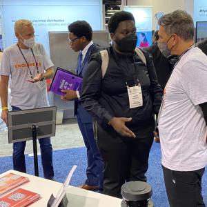 Rockwell’s Brian Taylor (far left) and Chris Nardecchia (far right), senior vice president and Chief Information and Digital Officer, meet with NSBE attendees.