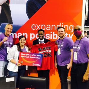 NSBE attendee Rasheed Martin (center) celebrates his offer with (from left to right) Rockwell’s Brian Taylor, Sabha Museteif, Andrew Marotta, and Derek Gallon.