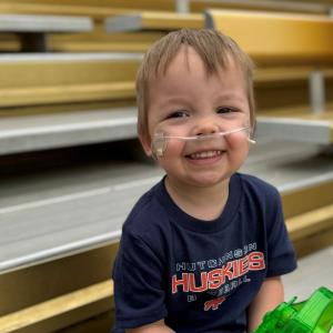 Toddler Cameron Olson shown with breathing apparatus.