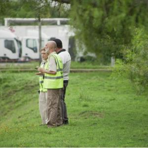 3 people meet out in the field