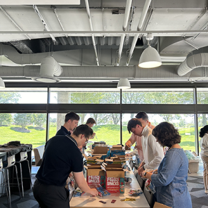 People packing boxes on a table