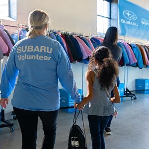 looking at racks of clothing