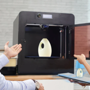 2 people using a 3D printer