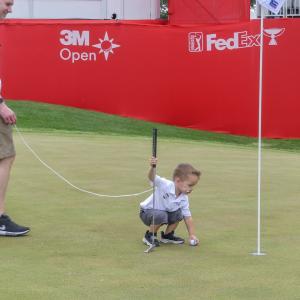 Cameron shown on the golf green with his dad.